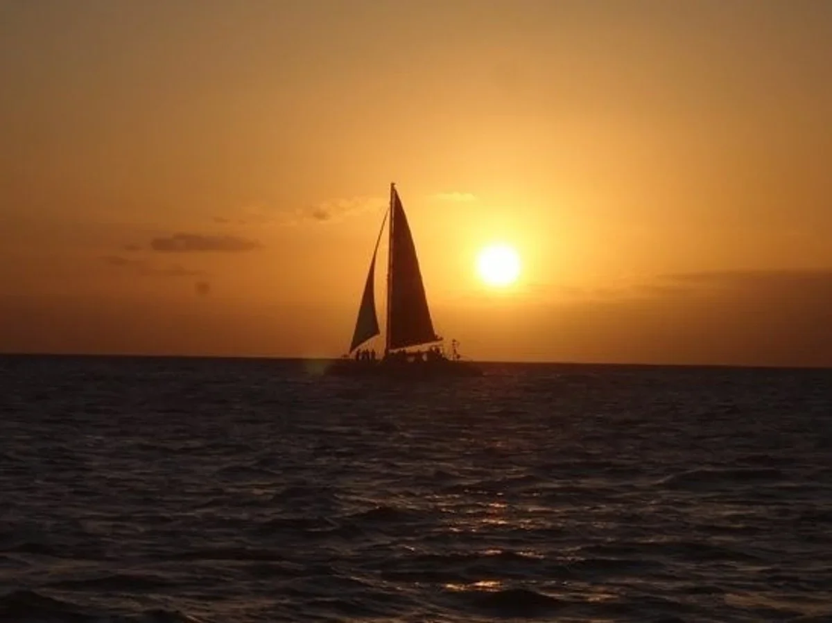 Maita'i catamaran sailing off Waikiki at sunset