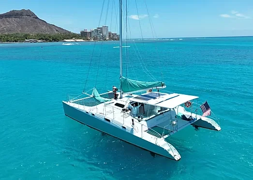 48-foot private sailing catamaran off Waikiki with Diamond Head behind