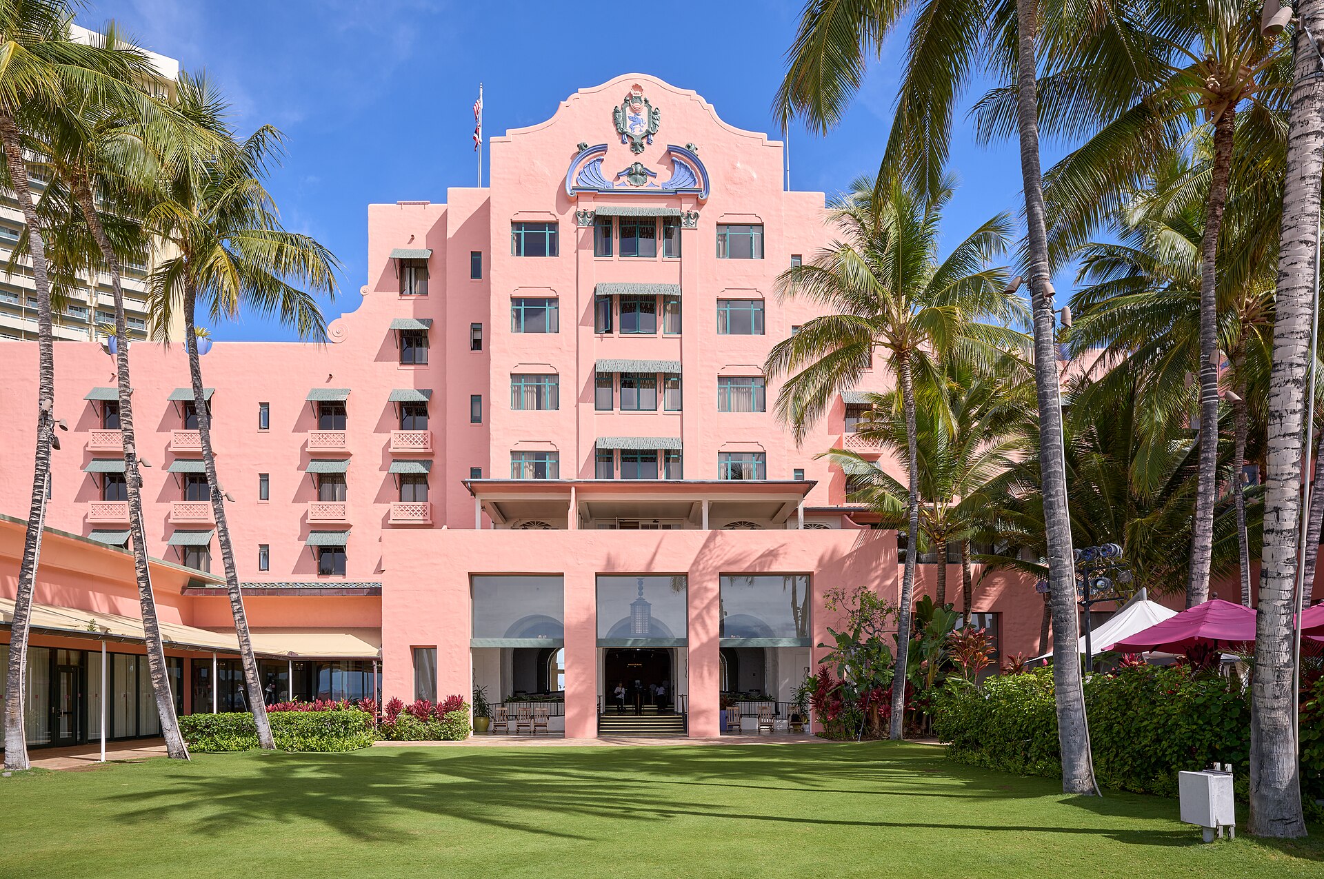 Royal Hawaiian Hotel, Waikiki, Oahu — pink palace surrounded by palm trees at dusk