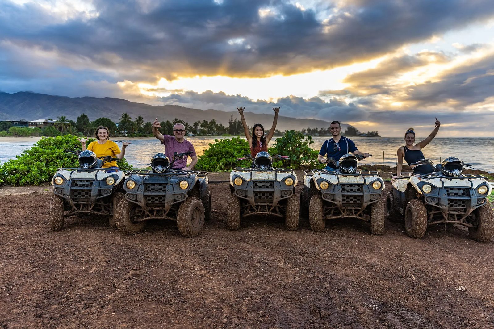 A group on ATVs at the shoreline in Waialua at sunset, Oahu North Shore