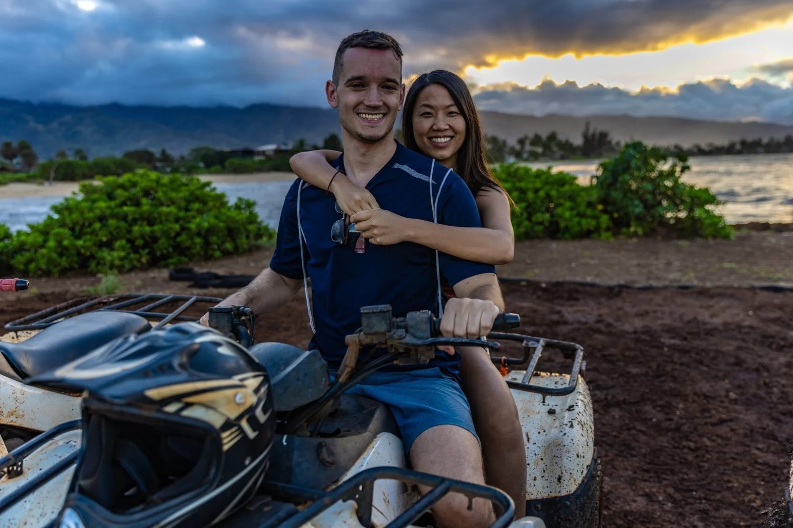 ATVs lined up at the shoreline in Waialua as the sun goes down