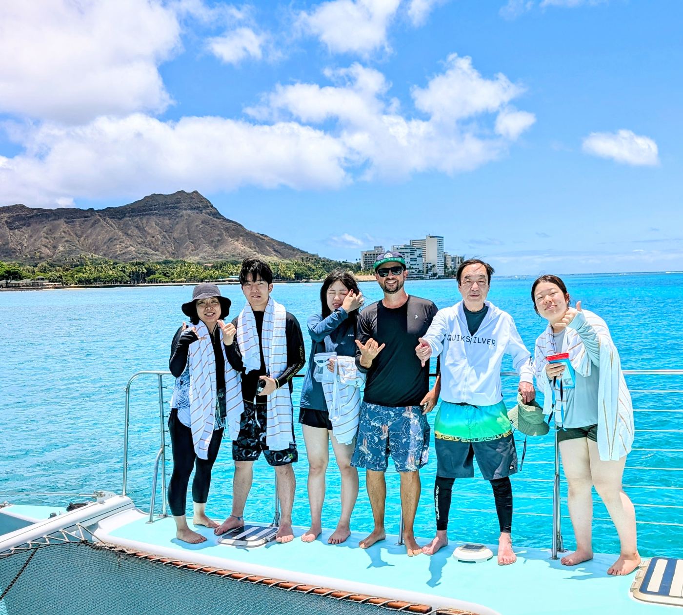A private group posing on the bow with Diamond Head behind them